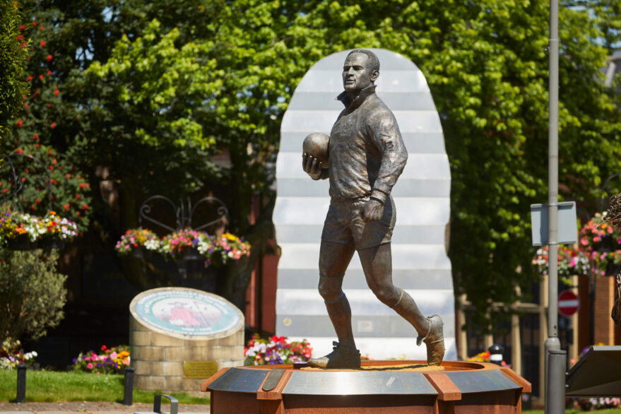 Statue of Wigan Warriors rugby player Billy Boston in Wigan Town Centre